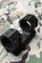 Photo of Quick disconnect sniper cantilever scope mount on fabric with camouflage pattern, closeup