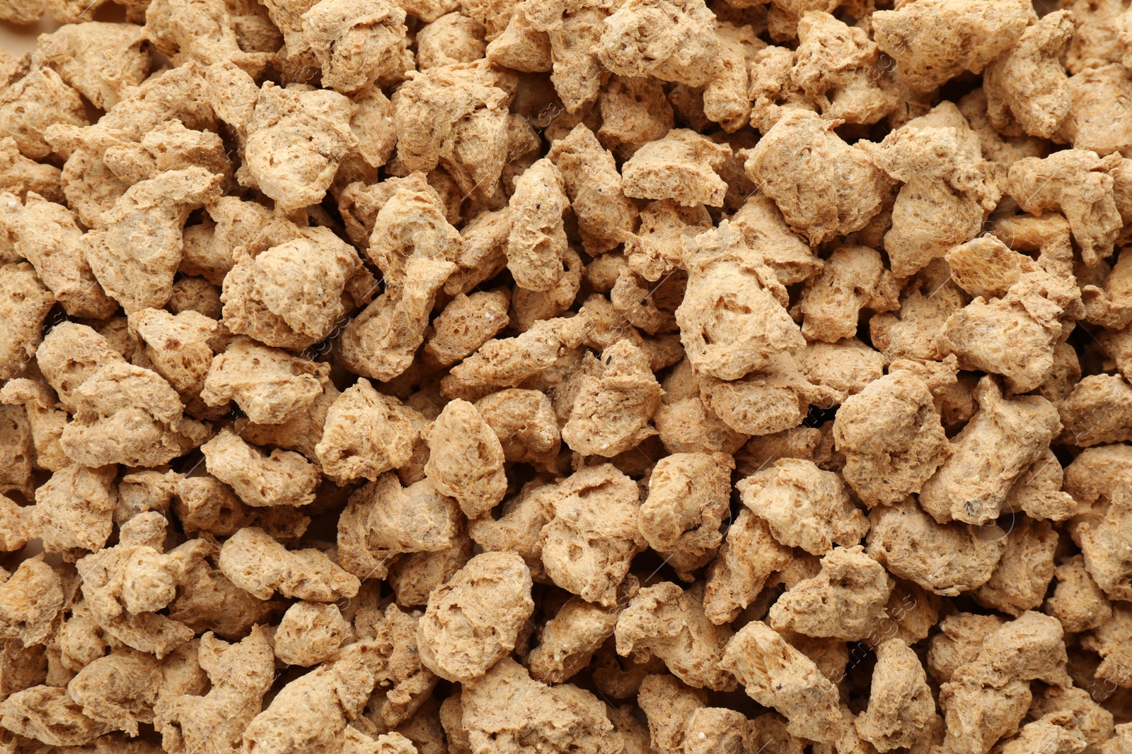 Photo of Dehydrated soy meat chunks as background, top view