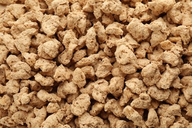 Photo of Dehydrated soy meat chunks as background, top view