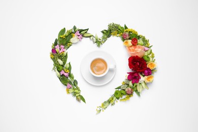 Beautiful heart shaped floral composition with cup of coffee on light background, flat lay