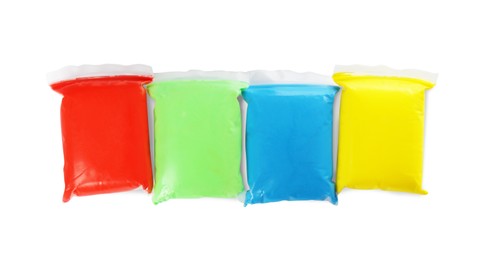 Photo of Packages of colorful play dough on white background, top view