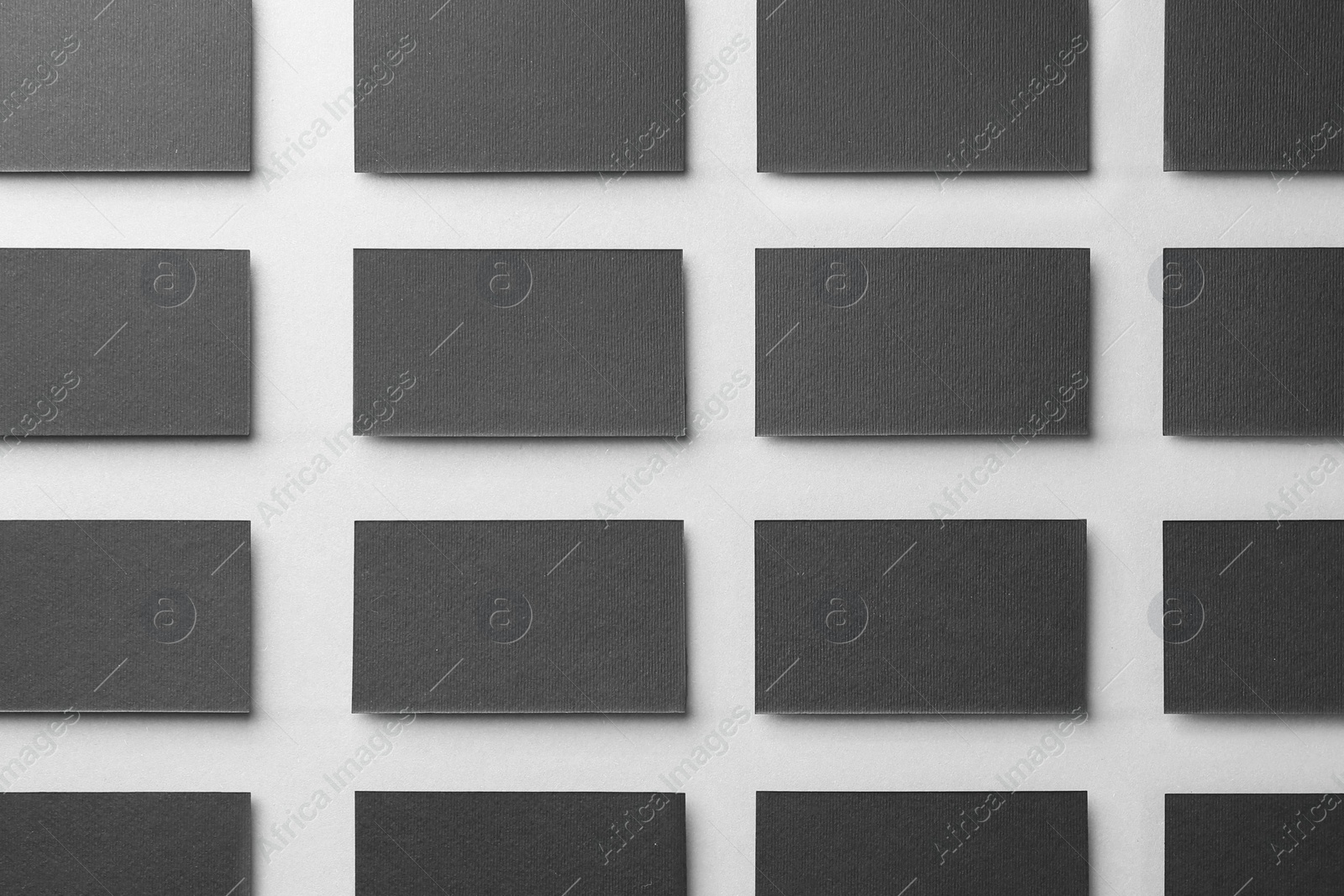 Photo of Blank black business cards on light background, flat lay. Mockup for design