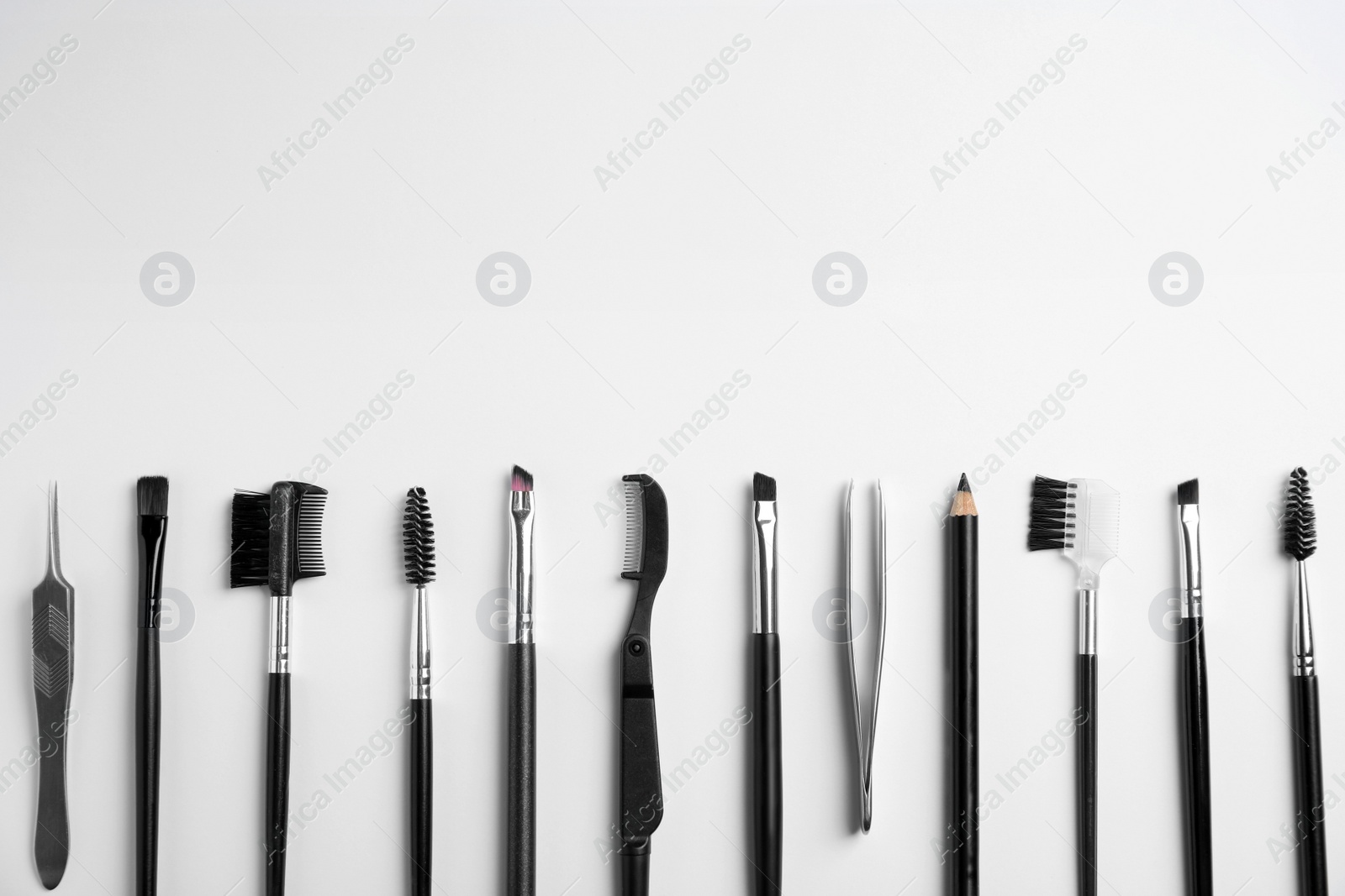 Photo of Set of professional eyebrow tools on white background, flat lay. Space for text