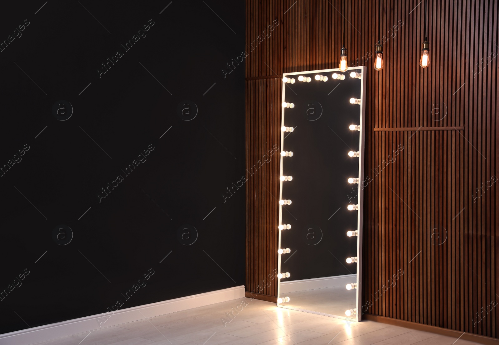 Photo of Large mirror with light bulbs indoors. Interior element