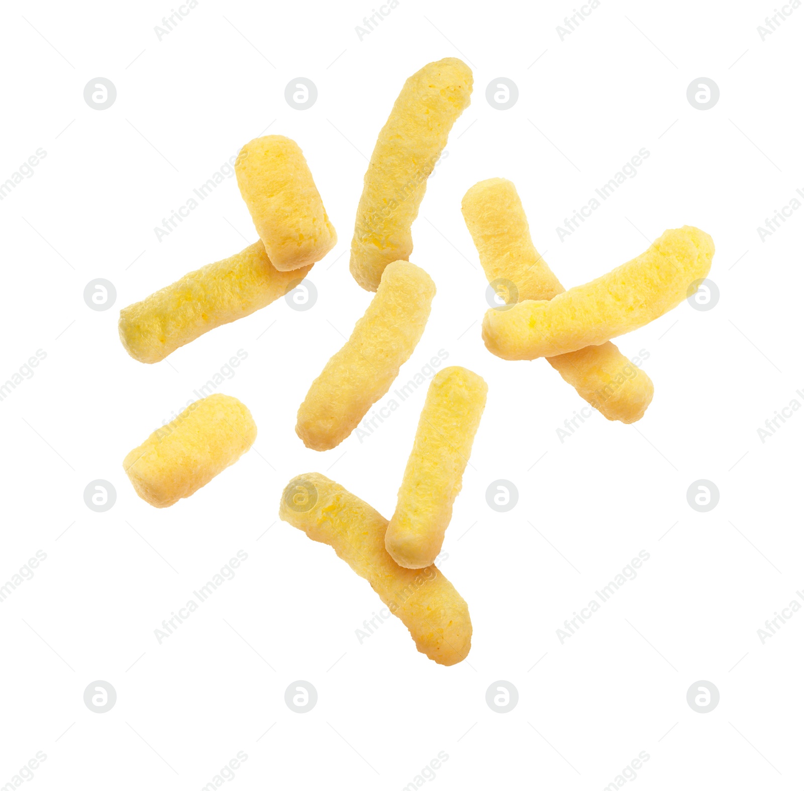 Image of Many tasty corn sticks falling on white background