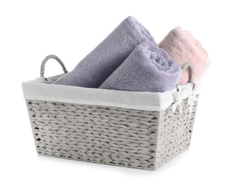 Photo of Basket with rolled towels isolated on white