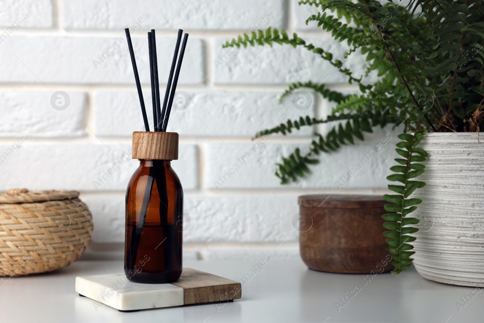 Photo of Air reed freshener on table against white wall