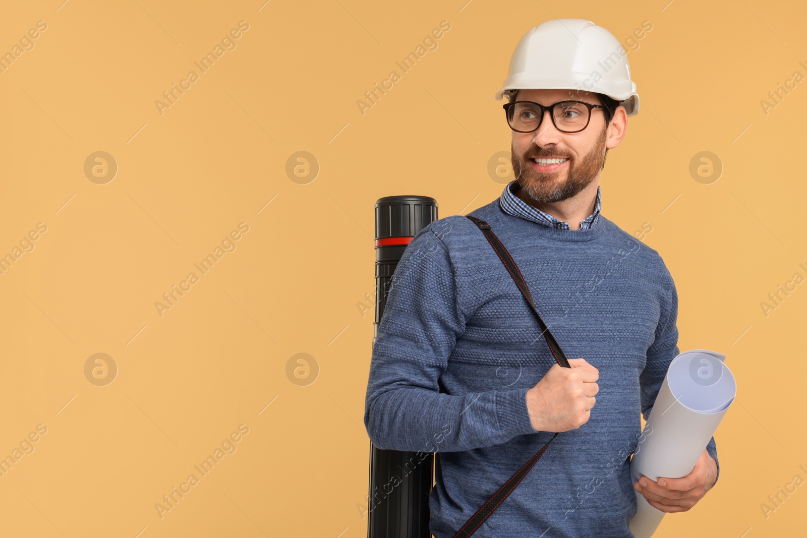 Photo of Architect in hard hat with drawing tube and draft on beige background, space for text