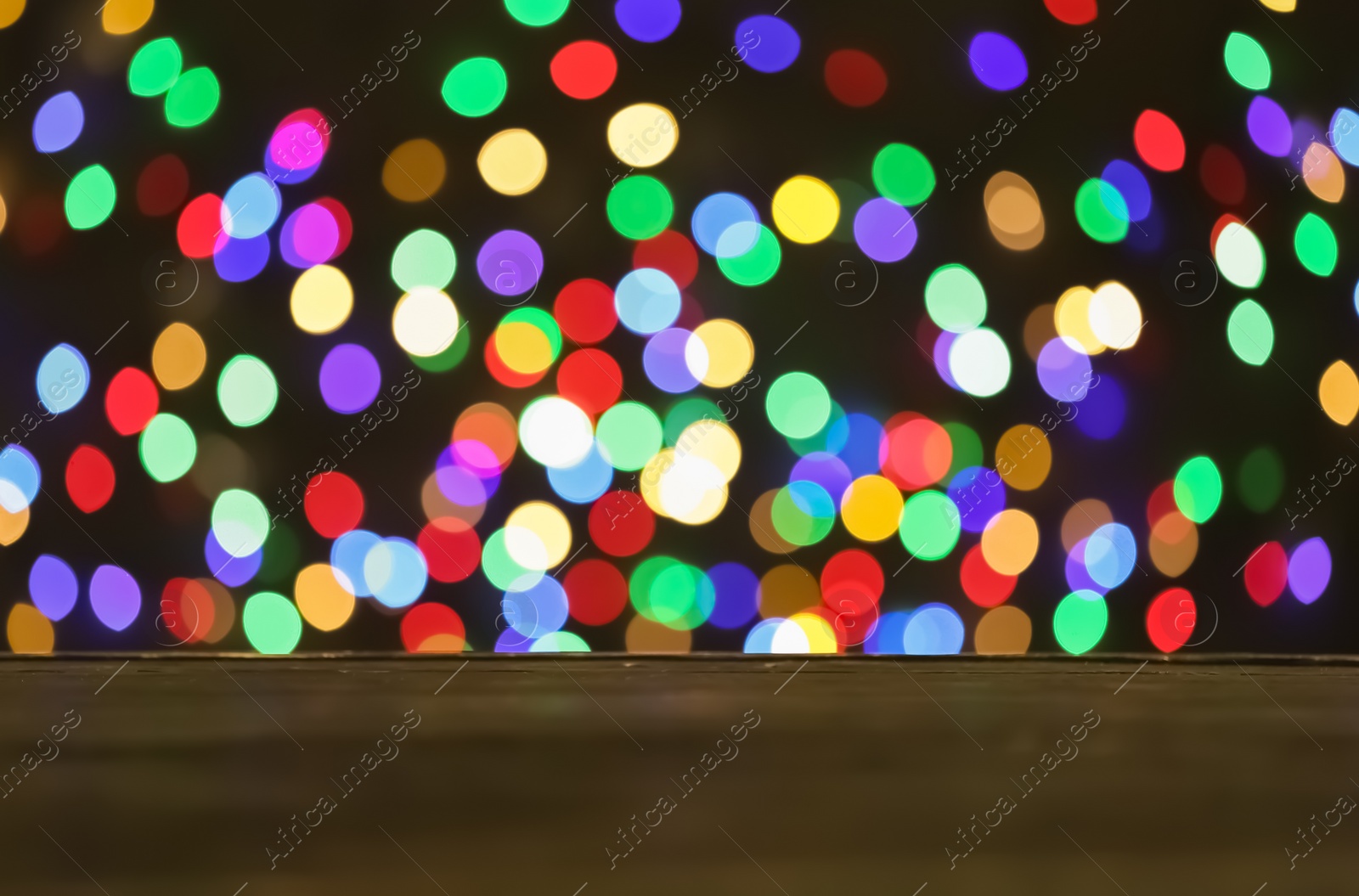 Photo of Empty wooden table against bokeh background. Mockup for design