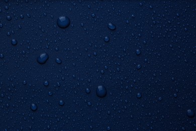 Many water drops on bright blue background