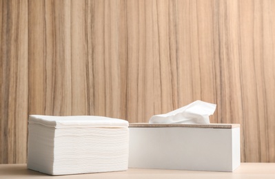 Clean paper tissues on wooden table. Space for text