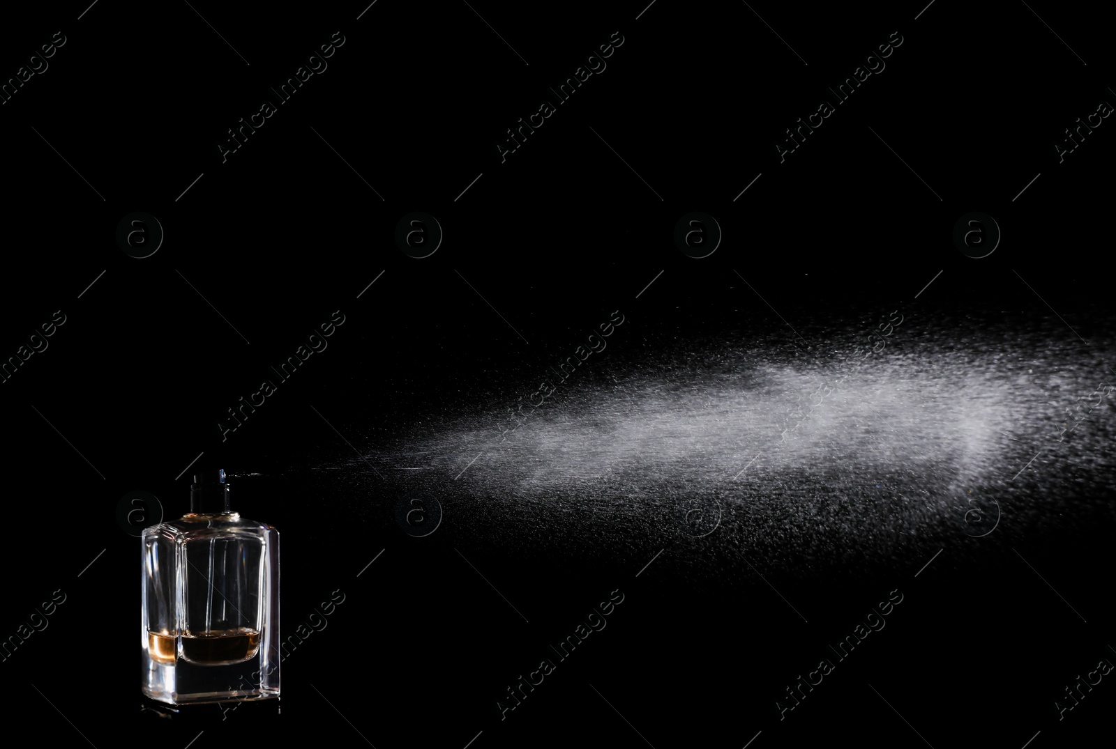 Photo of Woman spraying luxury perfume on black background, closeup