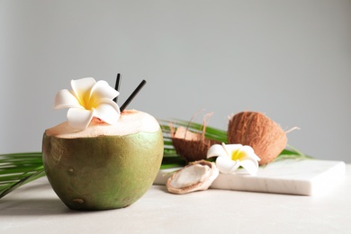 Photo of Beautiful composition with fresh green coconut on table against gray background