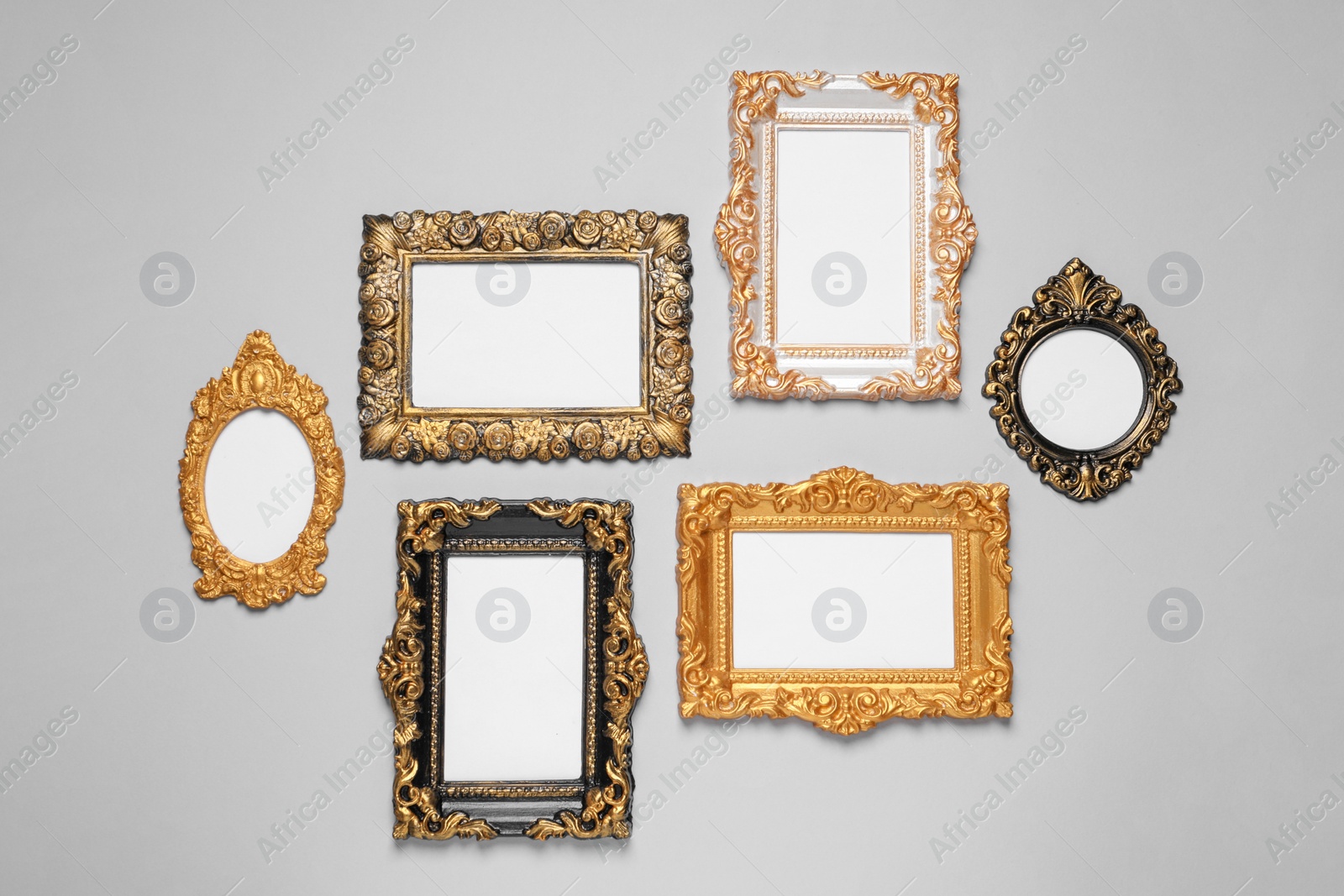 Photo of Empty vintage frames hanging on light gray wall