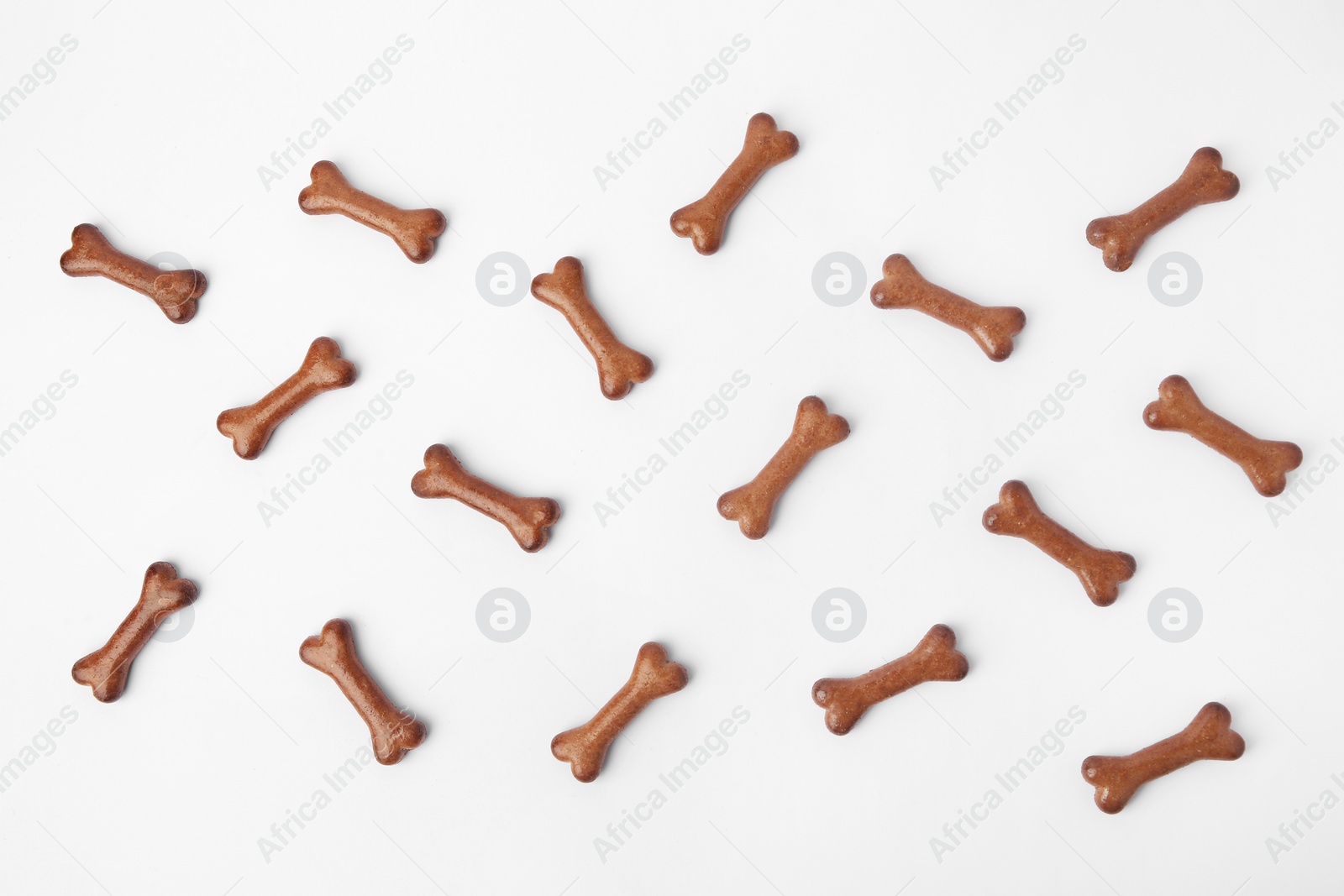 Photo of Flat lay composition with bone shaped dog cookies on white background