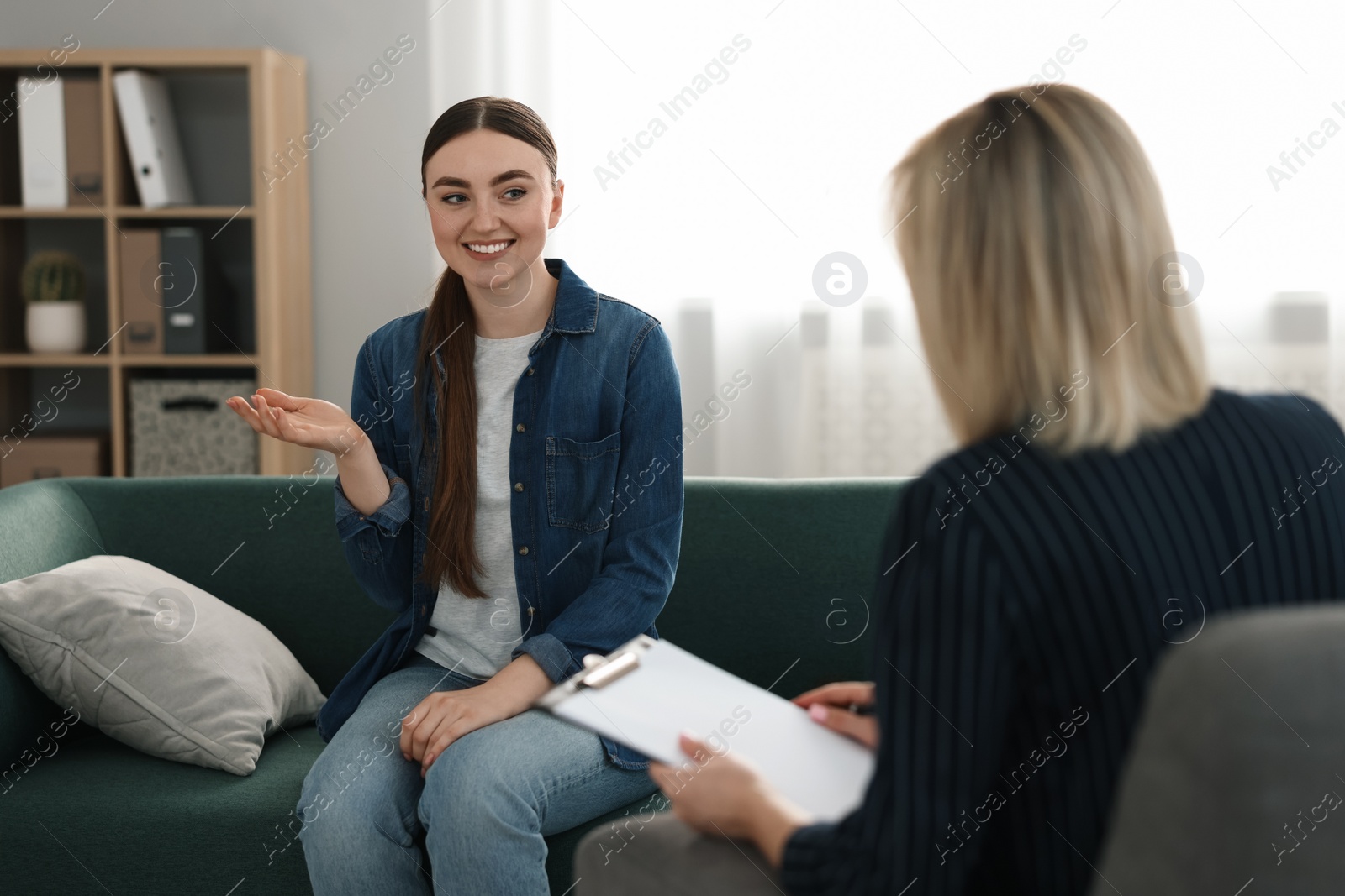 Photo of Professional psychotherapist working with patient in office