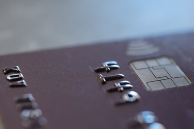 One credit card on gray background, macro view