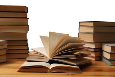 Many books on wooden table against white background. Library material