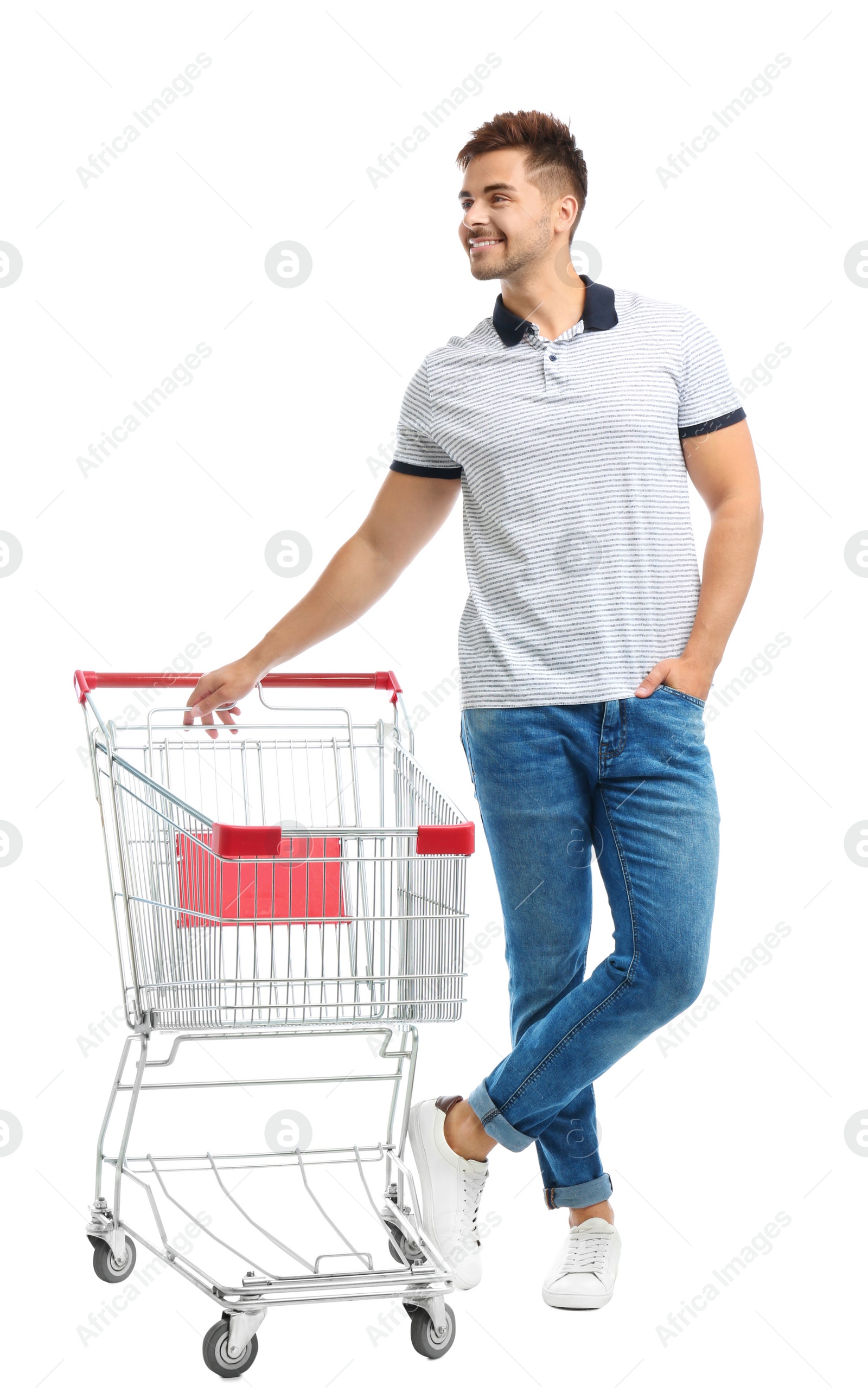 Photo of Young man with empty shopping cart on white background