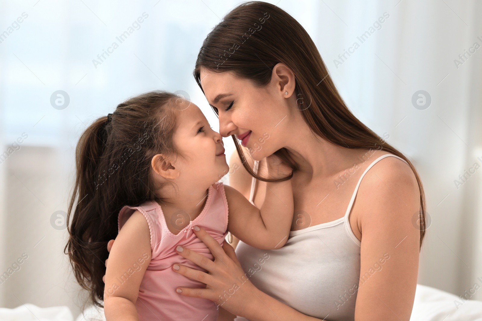 Photo of Happy mother with little daughter in bedroom