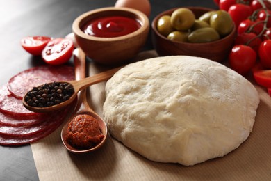 Photo of Pizza dough and products on table, closeup