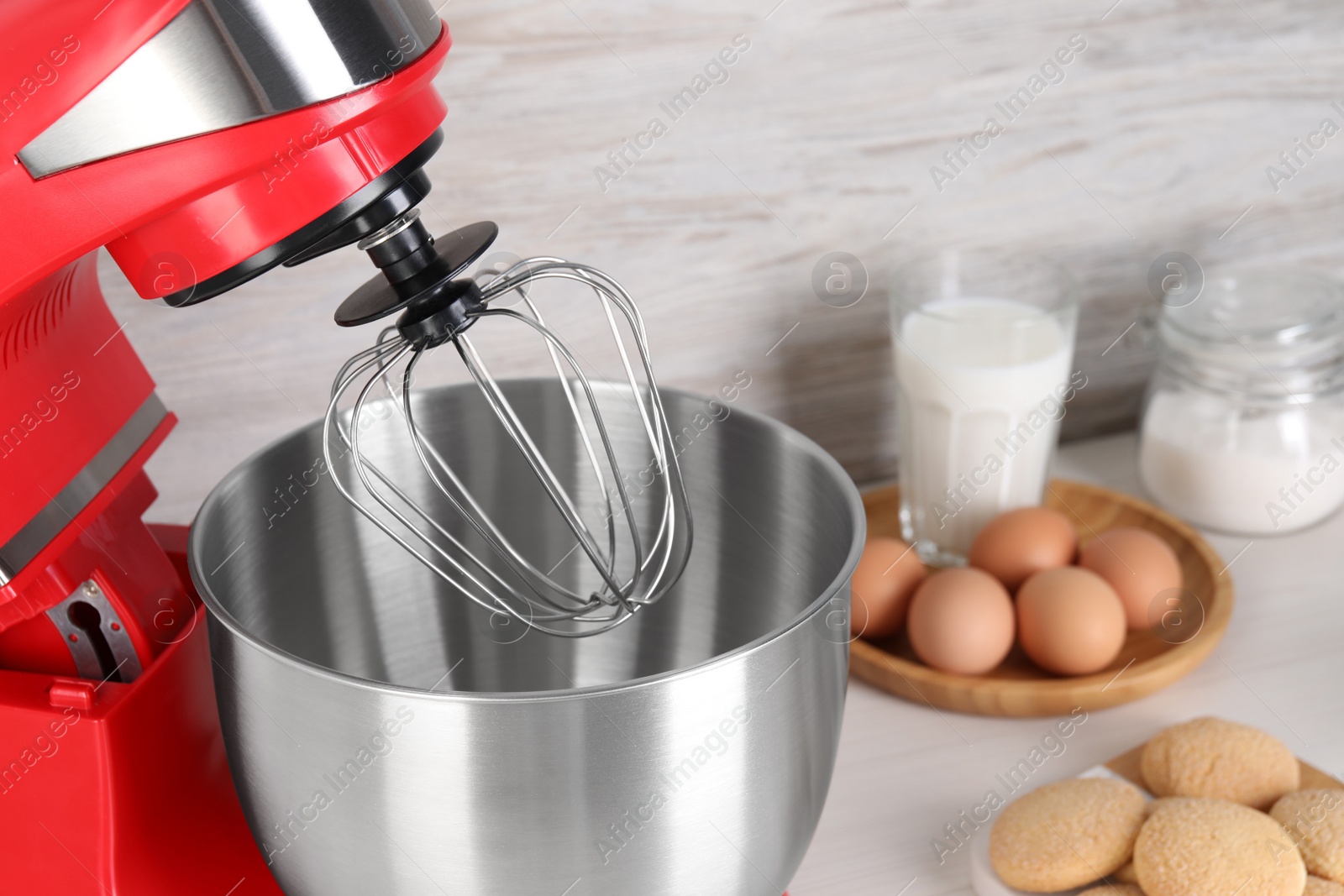 Photo of Closeup view of modern red stand mixer on table, space for text