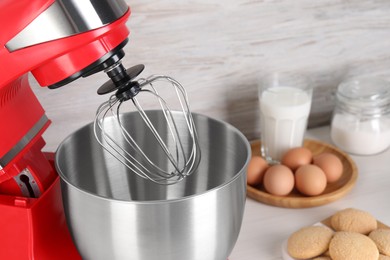 Photo of Closeup view of modern red stand mixer on table, space for text