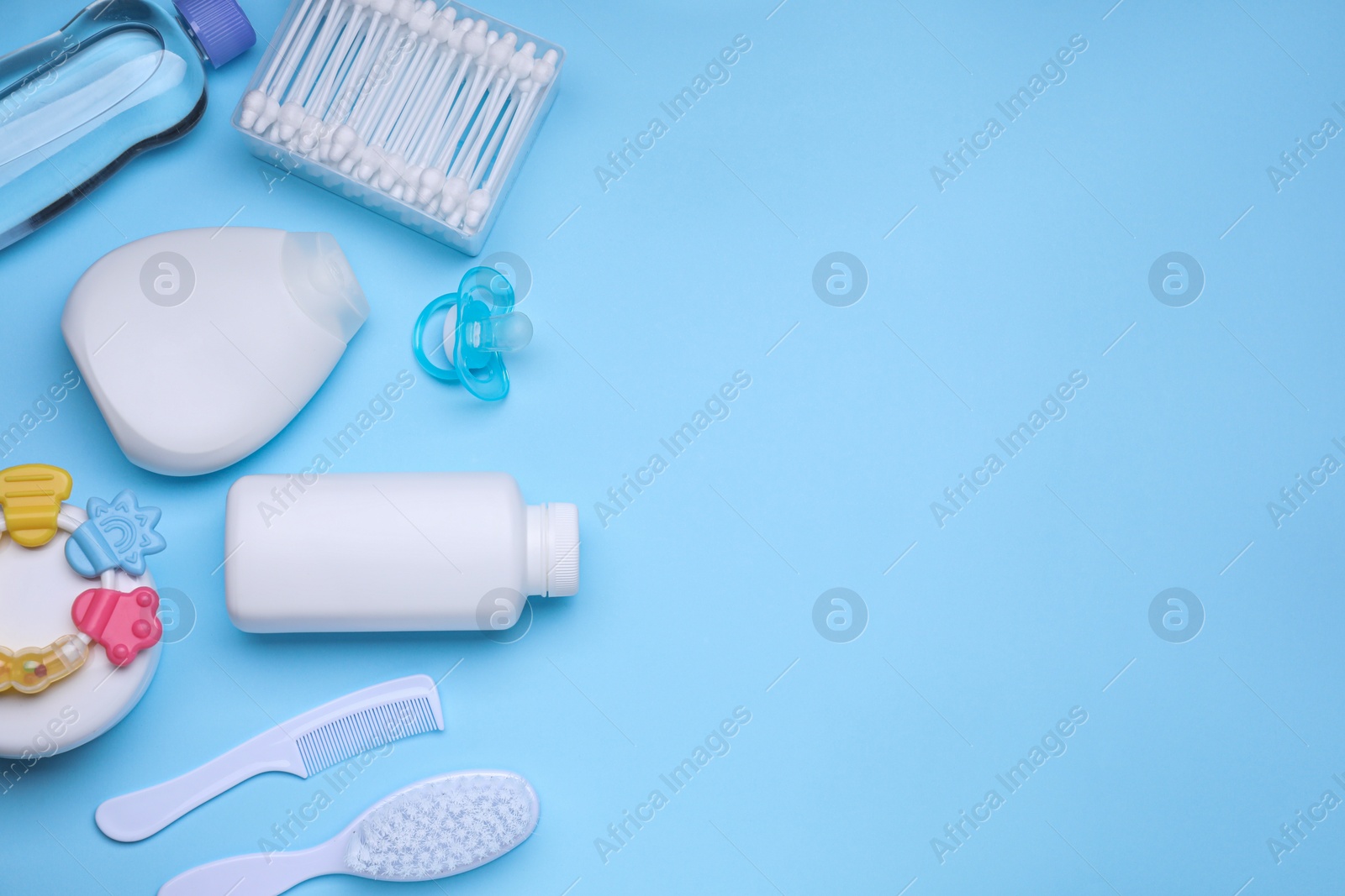 Photo of Flat lay composition with baby care products and accessories on light blue background, space for text