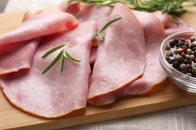 Photo of Slices of delicious ham with rosemary and spices on table, closeup
