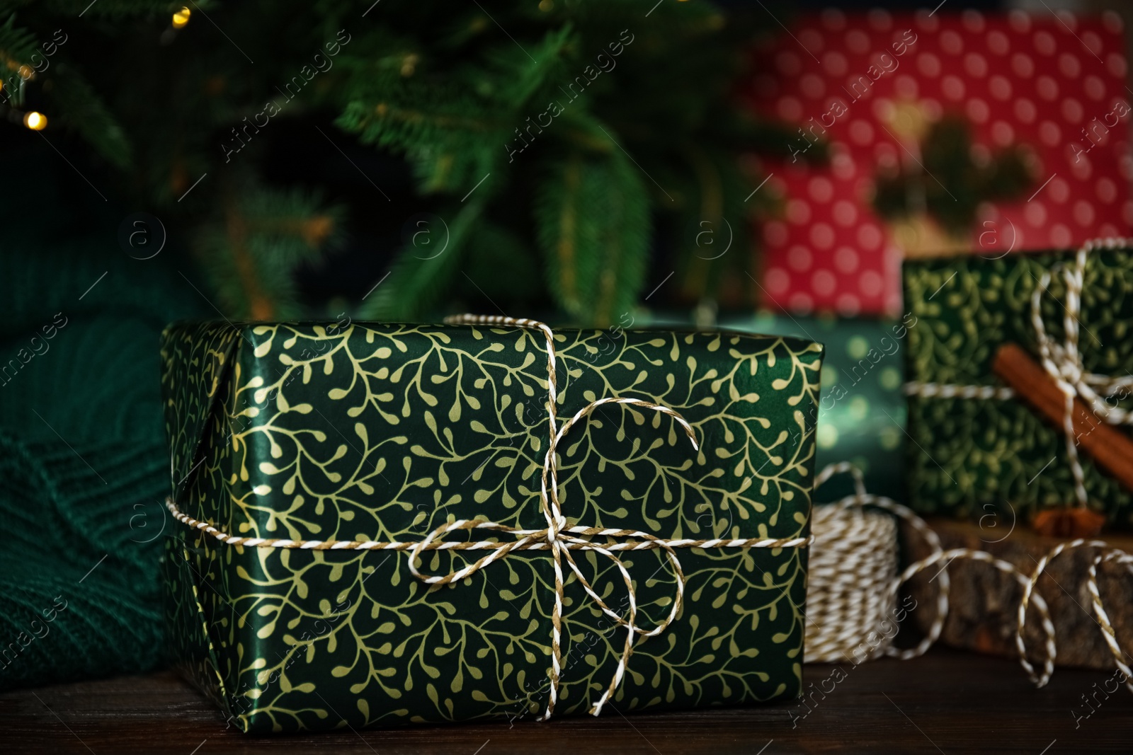 Photo of Composition with beautifully wrapped gift box on wooden table