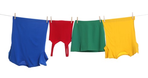 Photo of Different clothes drying on laundry line against white background