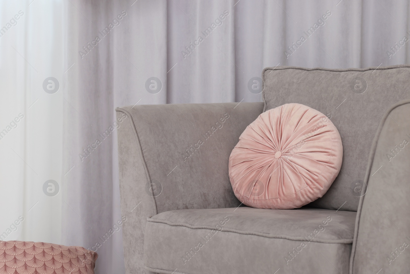 Photo of Stylish living room interior with comfortable armchair and beautiful window curtains