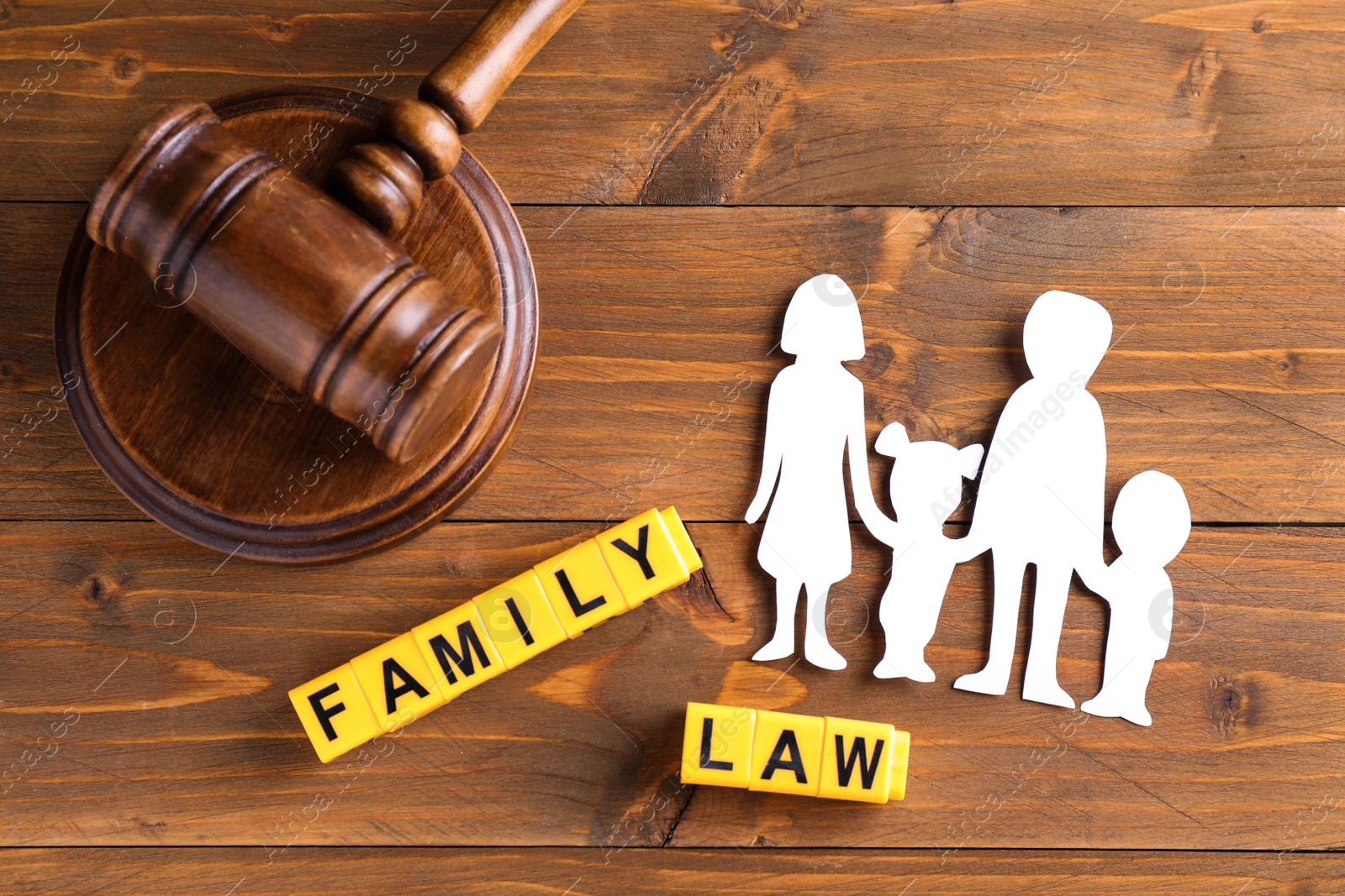 Photo of Flat lay composition with figure and gavel on wooden background. Family law concept