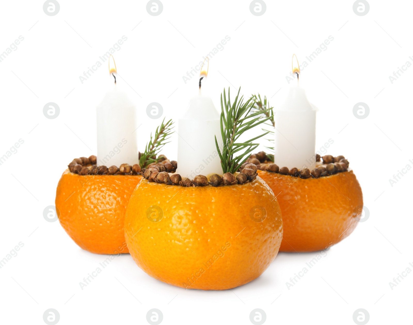 Photo of Candles in tangerine peels as holders on white background