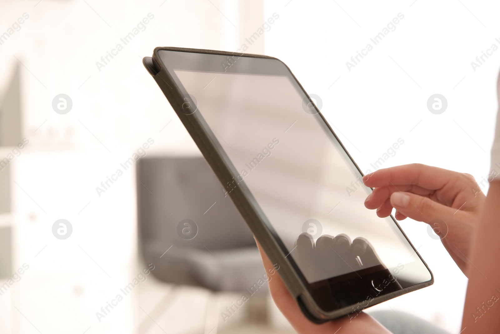 Photo of Woman working with modern tablet indoors, closeup