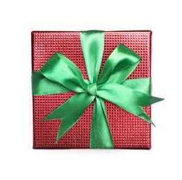 Photo of Christmas gift in box with green ribbon isolated on white, top view