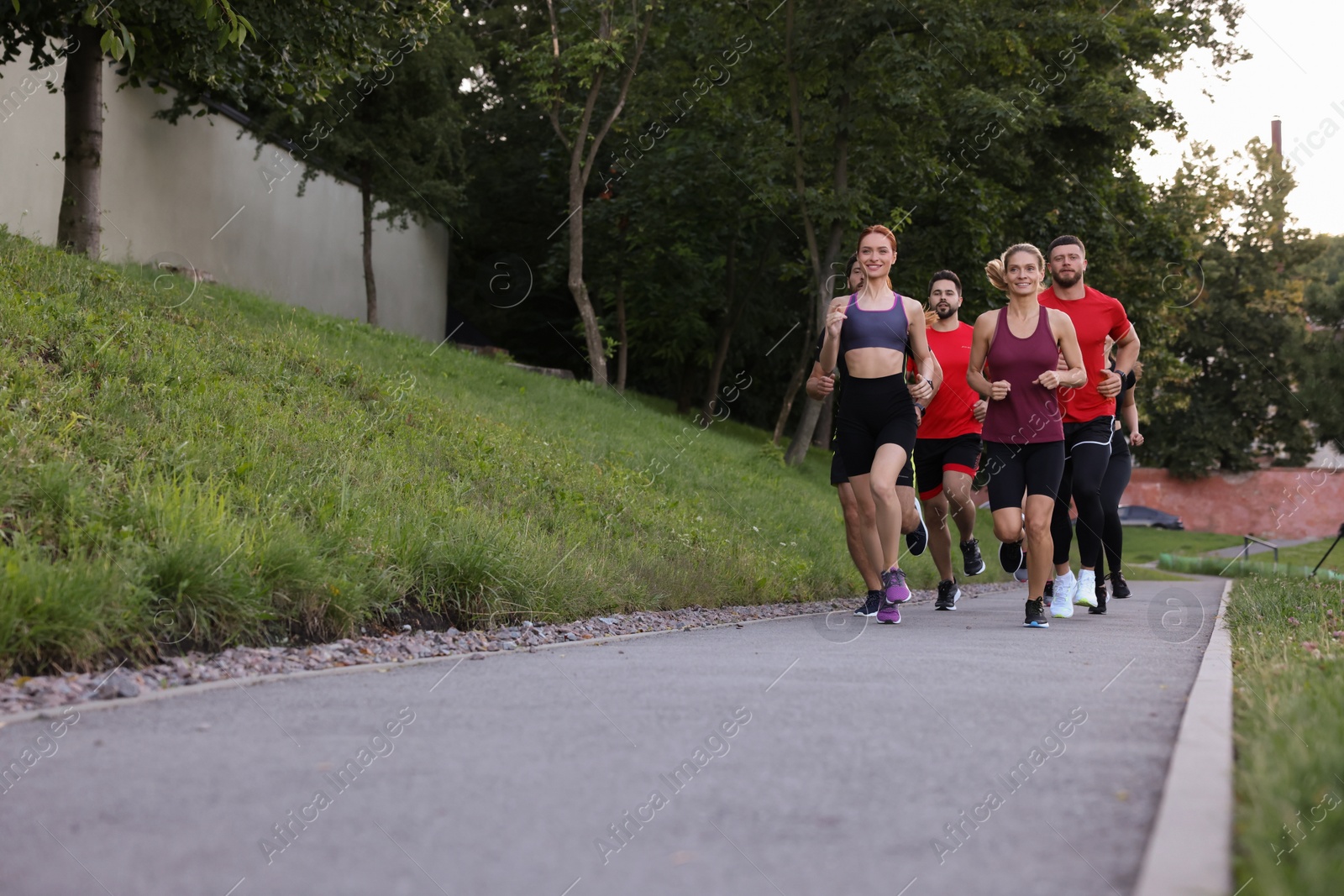 Photo of Group of people running outdoors. Space for text