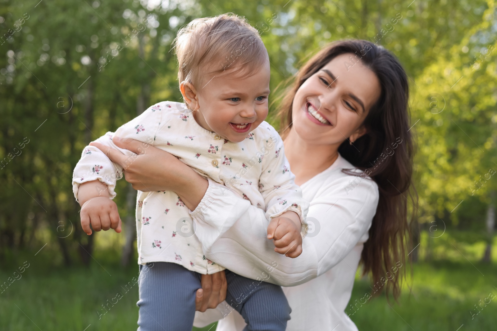 Photo of Happy mother with her cute baby in park on sunny day