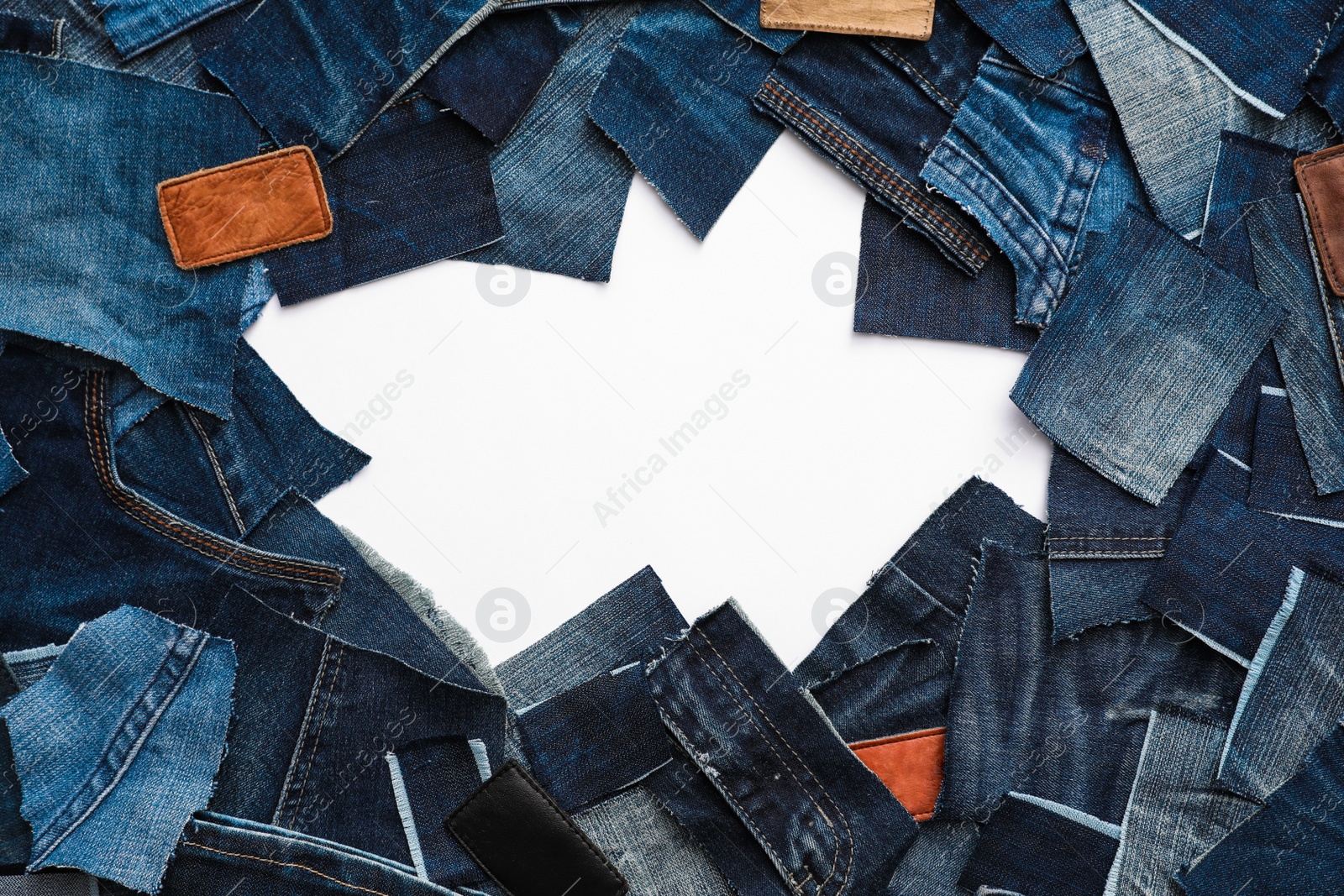 Photo of Frame made of cut jeans isolated on white. Space for text