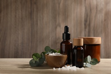 Composition with spa products and eucalyptus leaves on wooden table