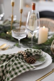 Christmas table setting with festive decor and dishware indoors