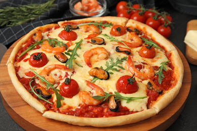 Delicious seafood pizza on black table, closeup