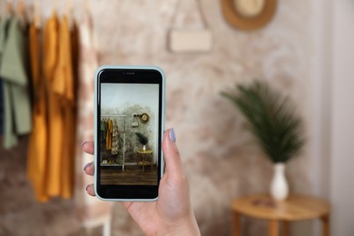 Woman taking photo of stylish clothes indoors, closeup