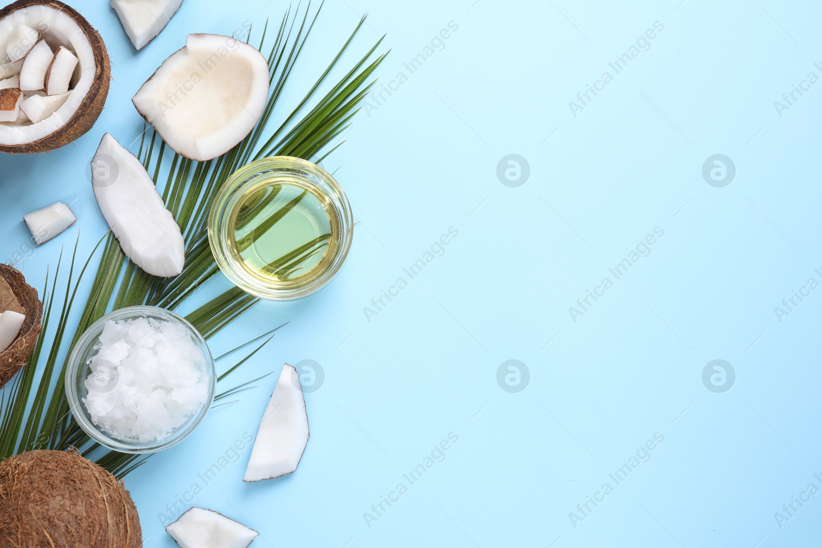 Photo of Flat lay composition with coconut oil on light blue background, space for text