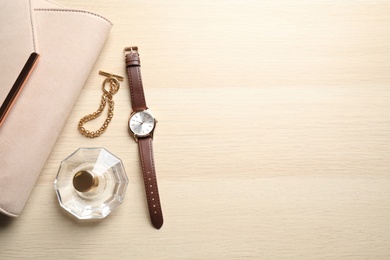 Photo of Flat lay composition with luxury wrist watch on wooden background. Space for text