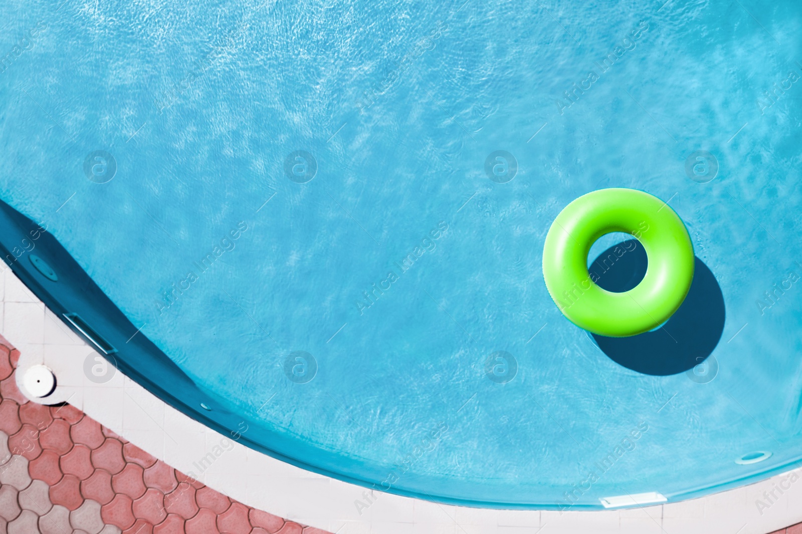 Image of Inflatable ring floating in swimming pool, top view with space for text. Summer vacation