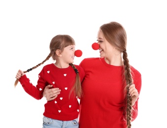 Happy woman and daughter with clown red noses on white background