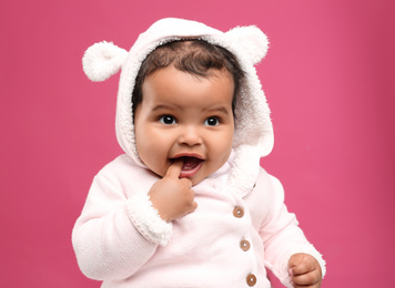 Photo of Cute African American baby on pink background