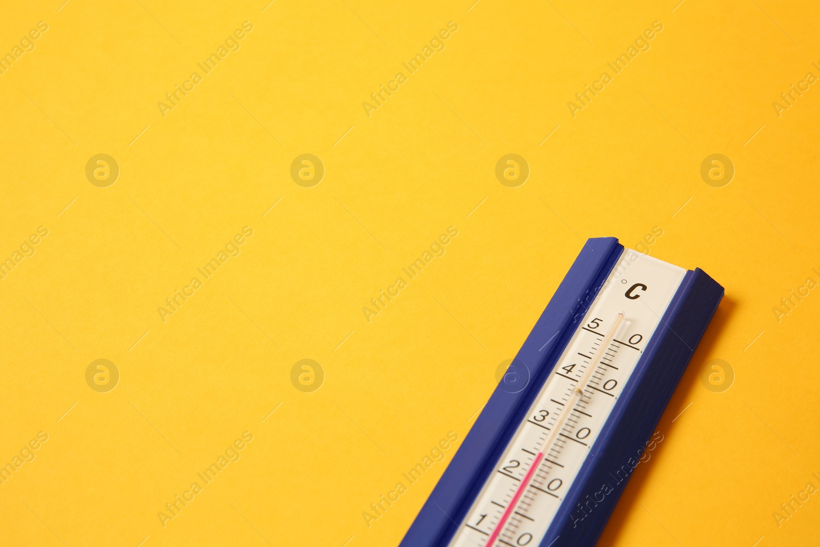 Photo of Weather thermometer on yellow background, closeup. Space for text