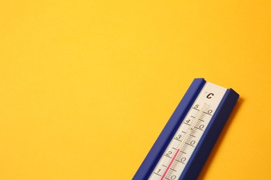 Weather thermometer on yellow background, closeup. Space for text